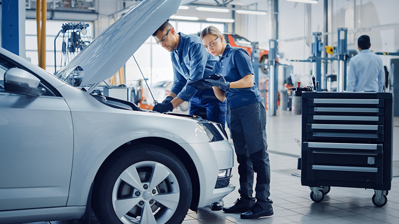 Two Mechanics are Inspecting a Car After They Got the Diagnostics Results.