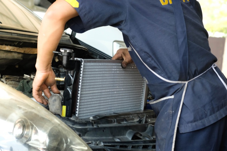  Car radiator,The car technicians is changing the new radiator in the car.