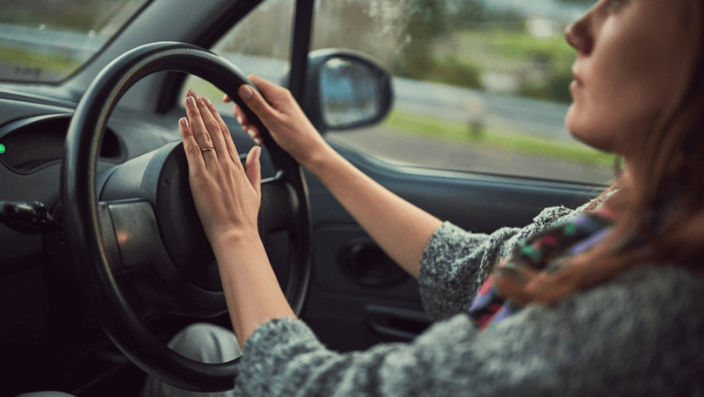 Woman, car and driving with honk on road for alert, emergency or traffic in travel, trip or transport.