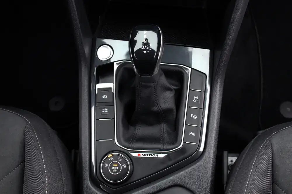 Close-up of an automatic gear shift lever, showcasing the modern transmission in a car with driving mode options.