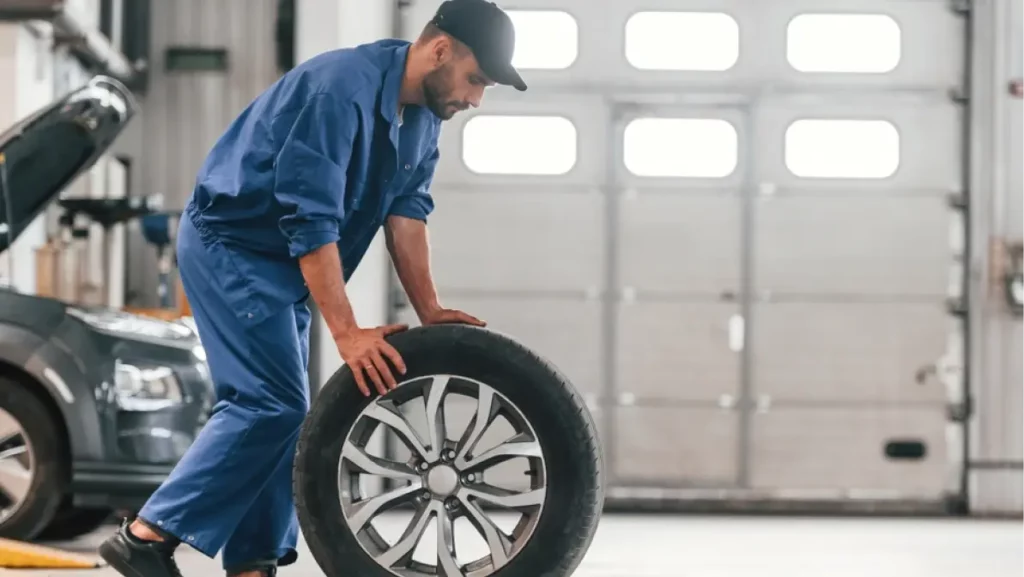 Auto mechanic working in garage.
