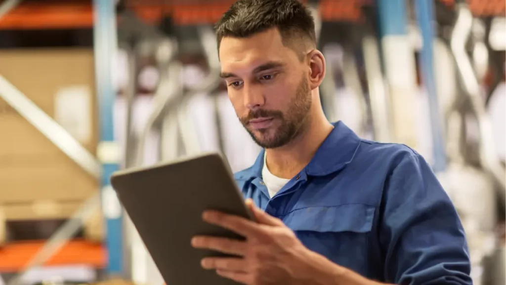 auto mechanic man or smith with tablet pc computer at workshop or warehouse