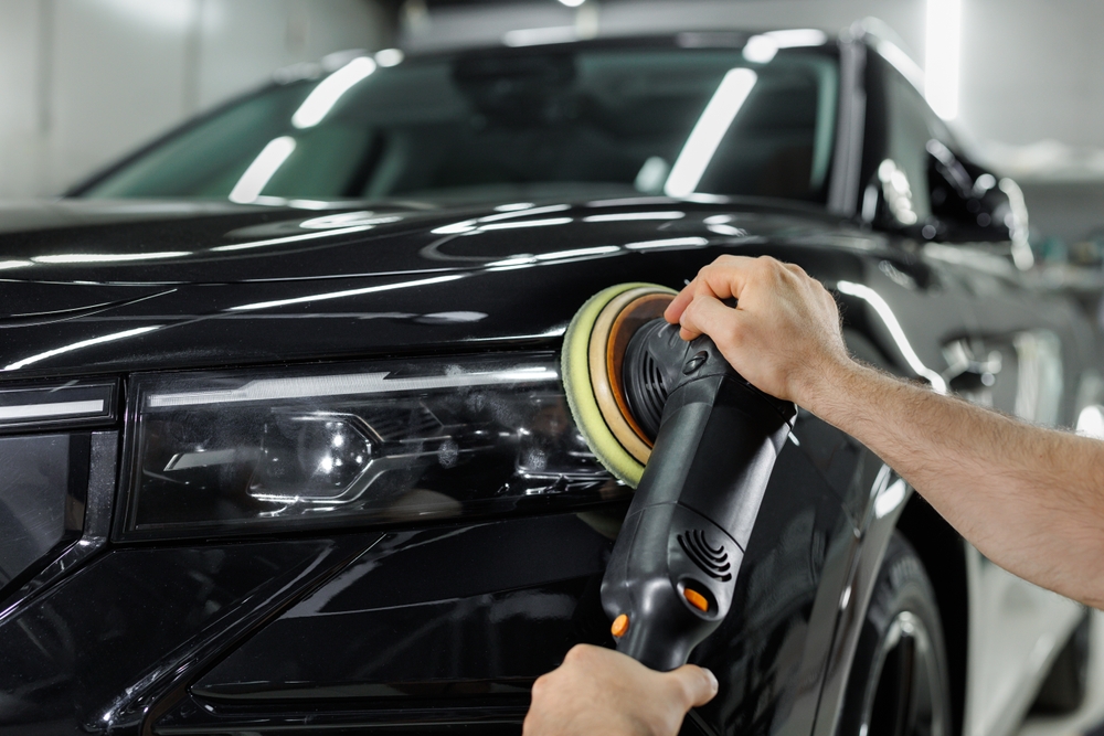 Car detailing and polishing process. Expert polishing car front lights in auto repair shop
